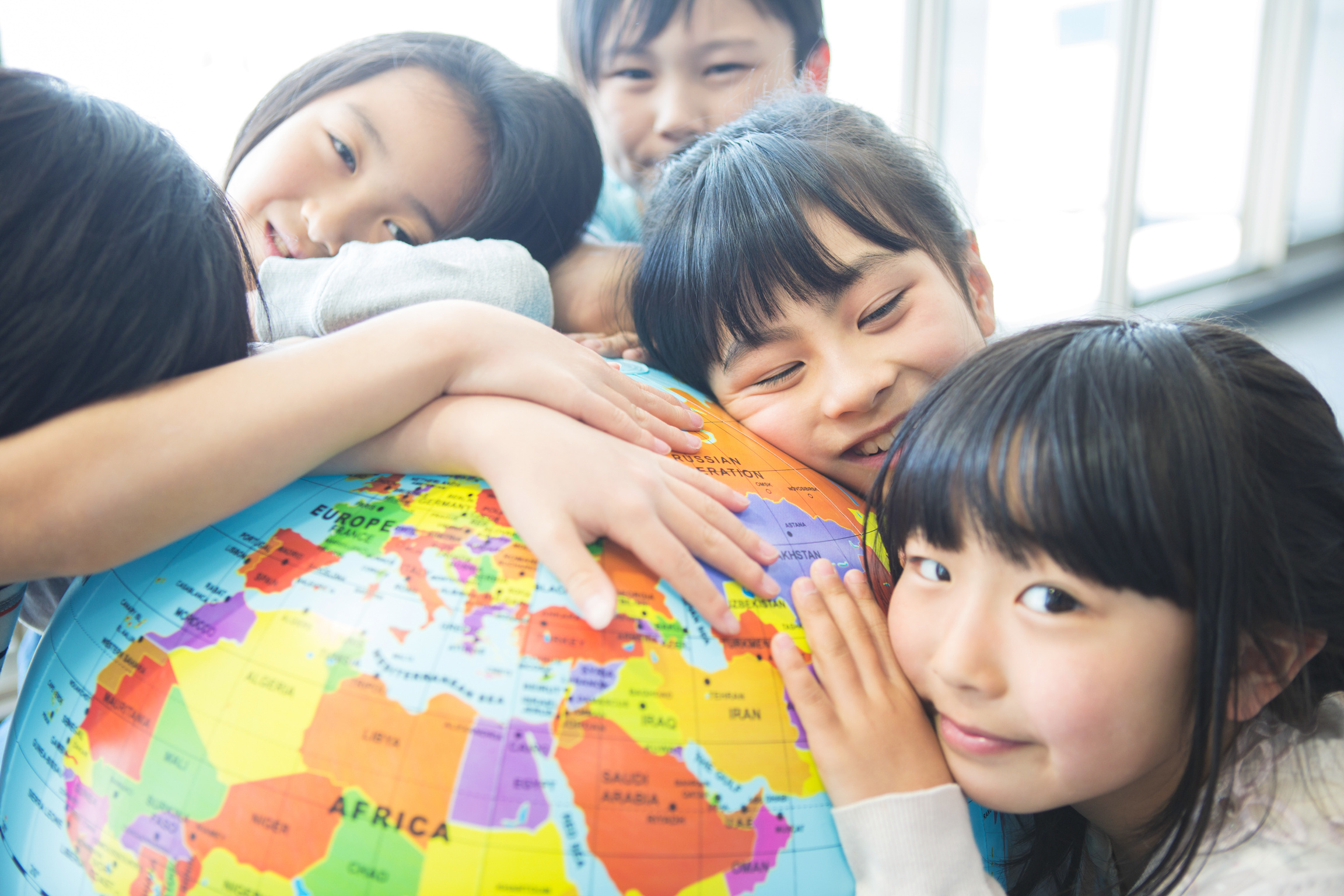 Elementary school students with globe